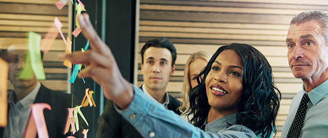 Woman leading an office team in a strategy meeting