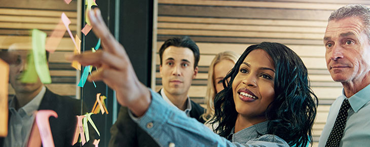 Woman leading an office team in a strategy meeting