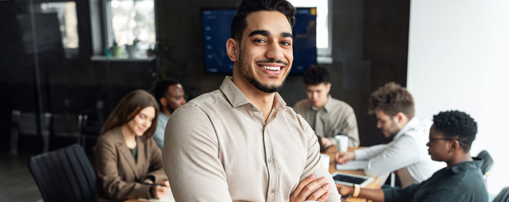 Young man sitting on a desk in administrative meeting