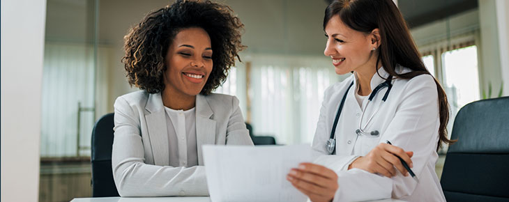 Smiling female administrator and doctor