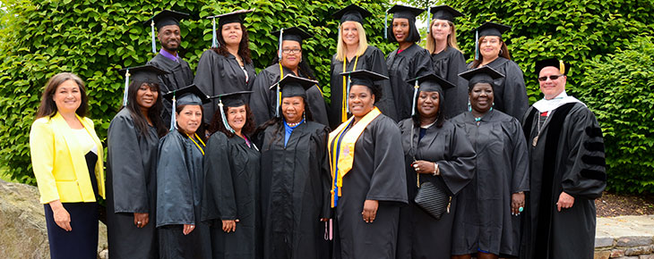 Women in Transistion program Graduates Wanda Warshauer and graduates in caps and gowns