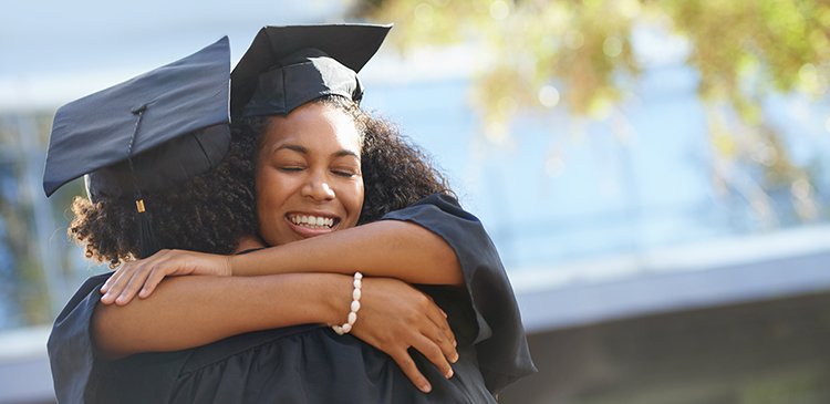 Two college graduates embracing