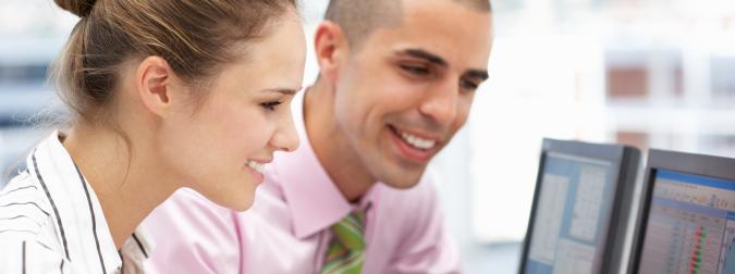 woman and man in office working on computer